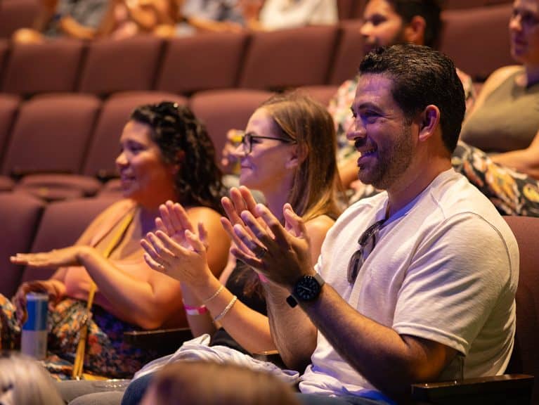 Audience participating in the dueling pianos show at Brea Fest