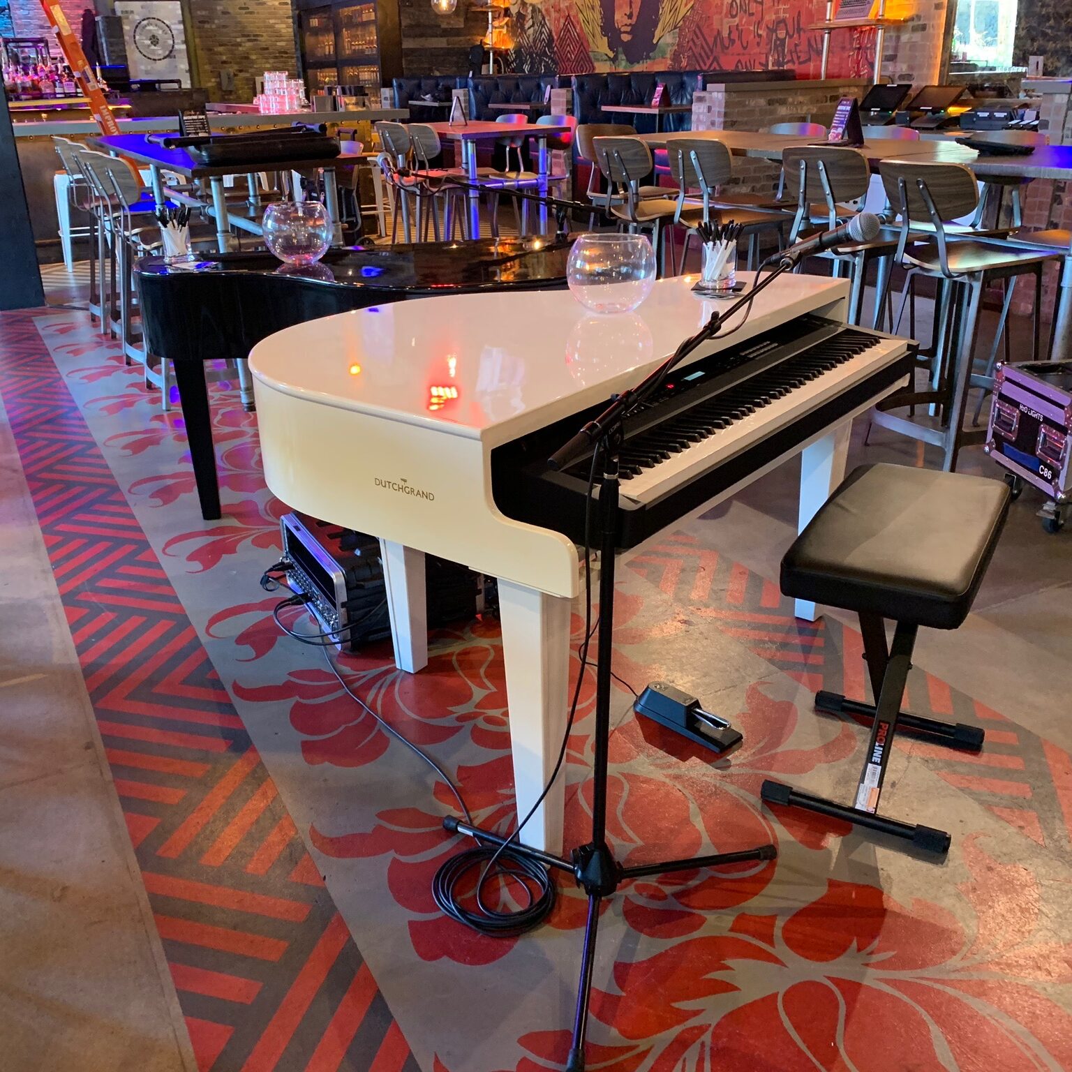 White piano shell rental with keyboard and black bench